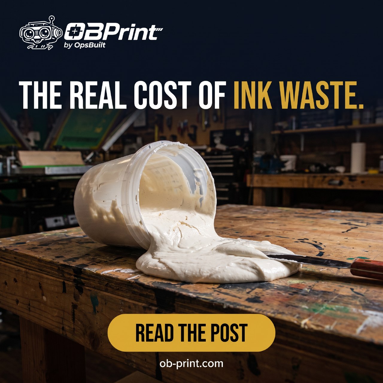 A container of white screen-printing ink spilled across a print shop worktable